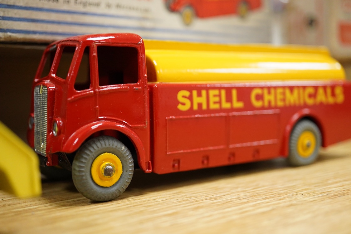 Five boxed Dinky Toys and Supertoys; Bedford Articulated Lorry in yellow (521), Leyland Cement Wagon (933), AEC tanker (991), Plymouth USA taxi (265) and Marrel Multi-Bucket Unit (966)